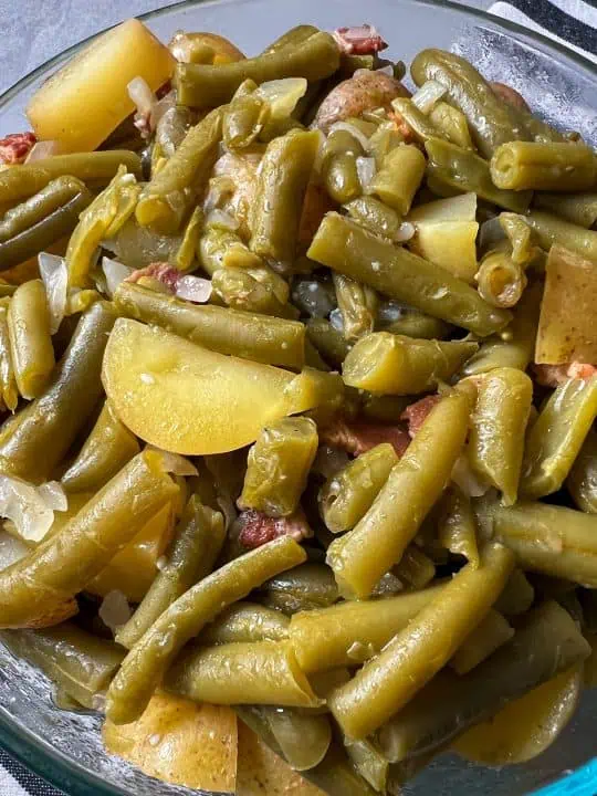 Close-up of southern green beans with potatoes, bacon, and onions.
