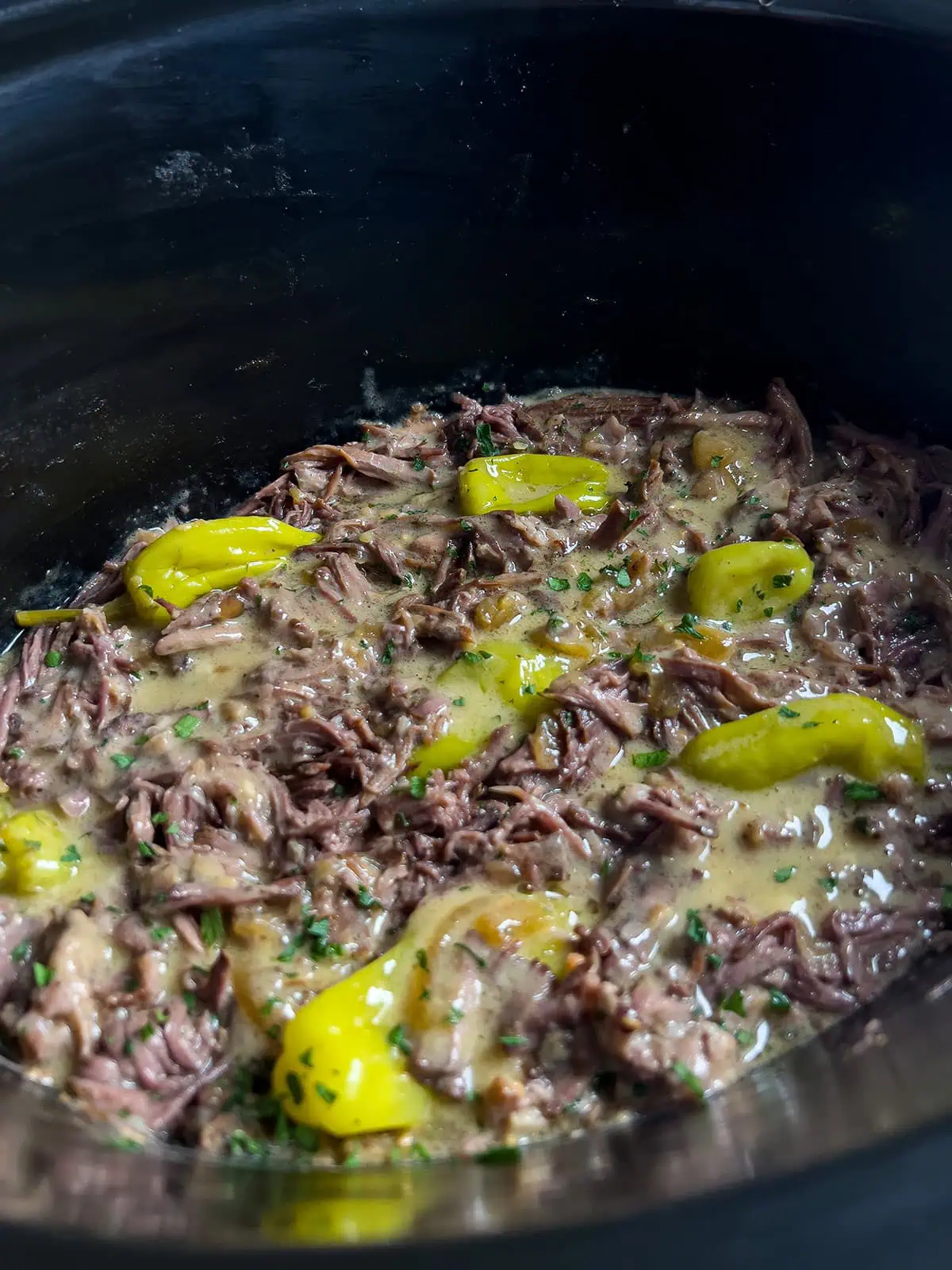 Shredded cream of mushroom Mississippi pot roast in creamy gravy with pepperoncini peppers
