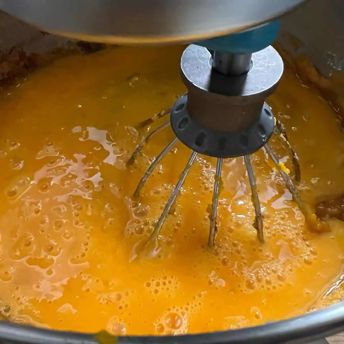 Sweet potato pie filling in a stand mixer after the eggs have been added in.