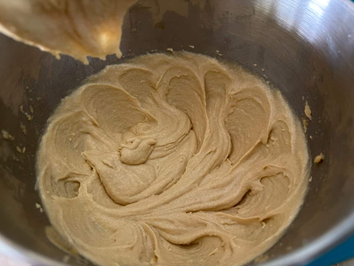 Browned butter, sugar, and eggs beaten together into a pale mixture in a stand mixer bowl.