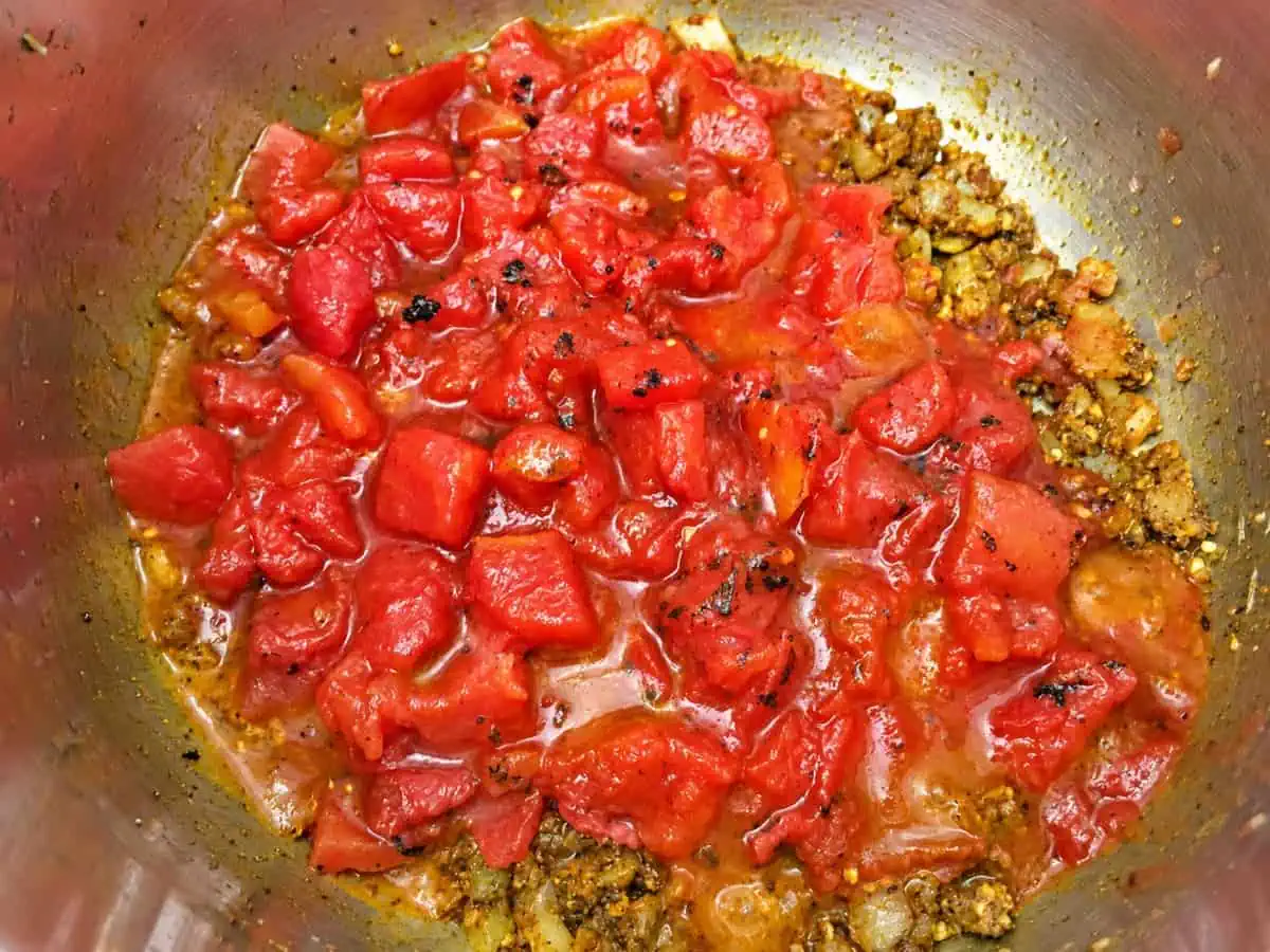 Fire-roasted tomatoes added to the toasted curry spices in the Instant Pot.