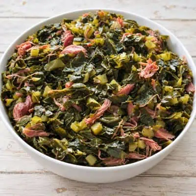 Southern collard greens with smoked turkey and bacon in rich pot liquor.